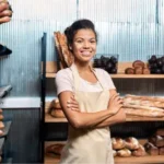 Happy Bread Shop Business Owner Stands with Arms Folded