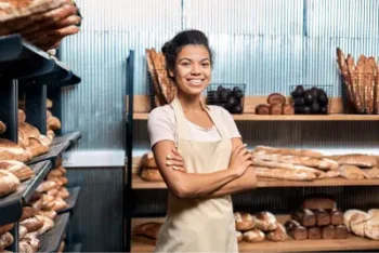 Happy Bread Shop Business Owner Stands with Arms Folded