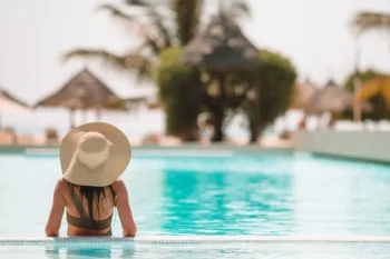 Woman enjoying pool of hotel using mosquito prevention services