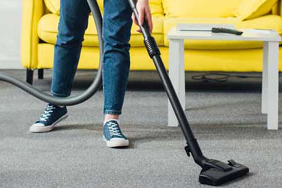 Person steam cleaning carpet - Keep bed bugs out of your home with Bug Out in St. Louis